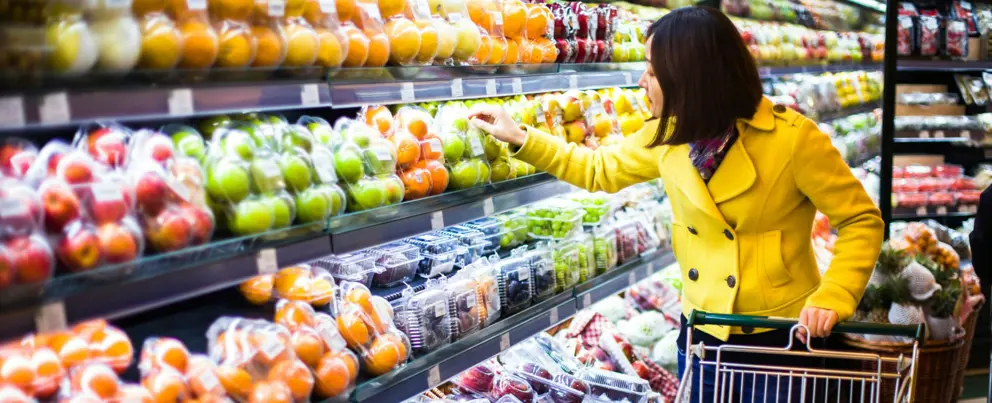 Woman shopping for fruit in grocery store